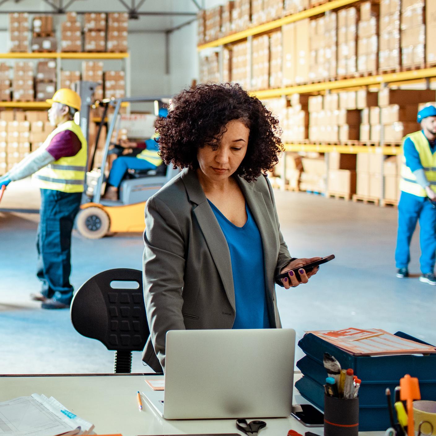 Warehouse manager using a laptop