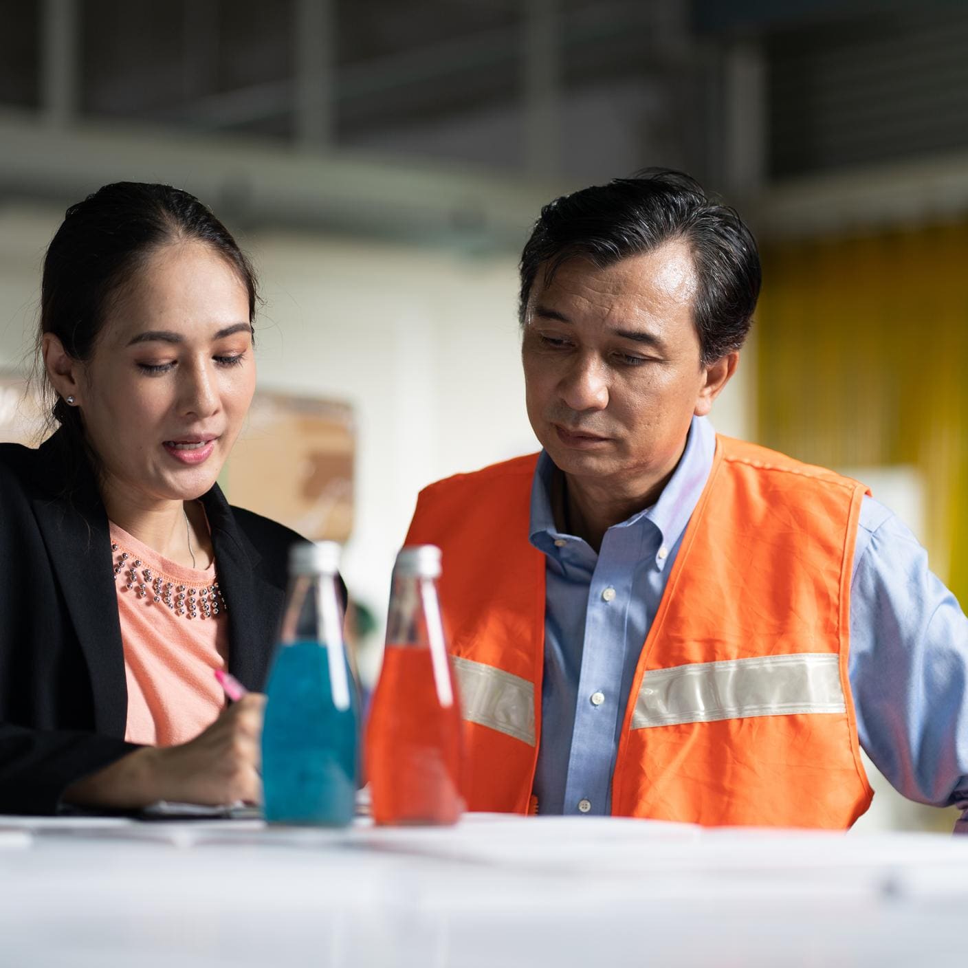 Business woman and man discussing warehouse export