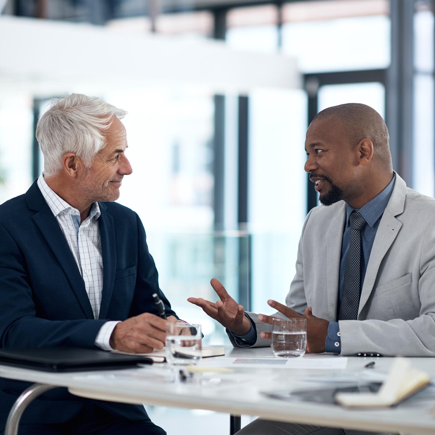 two businessmen having a discussion in an office