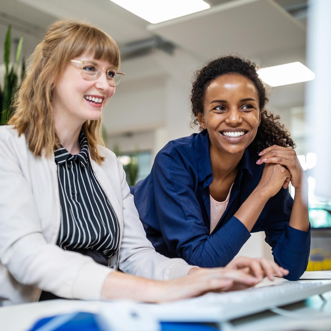 Health and safety - Multi-ethnic female entrepreneurs looking at computer in creative office