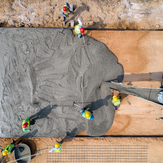 A view of workers applying concrete 