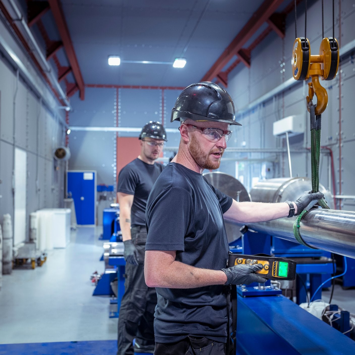 Engineers fitting new barrel to a two stage gas gun which creates nuclear fusion in a nuclear fusion research facility