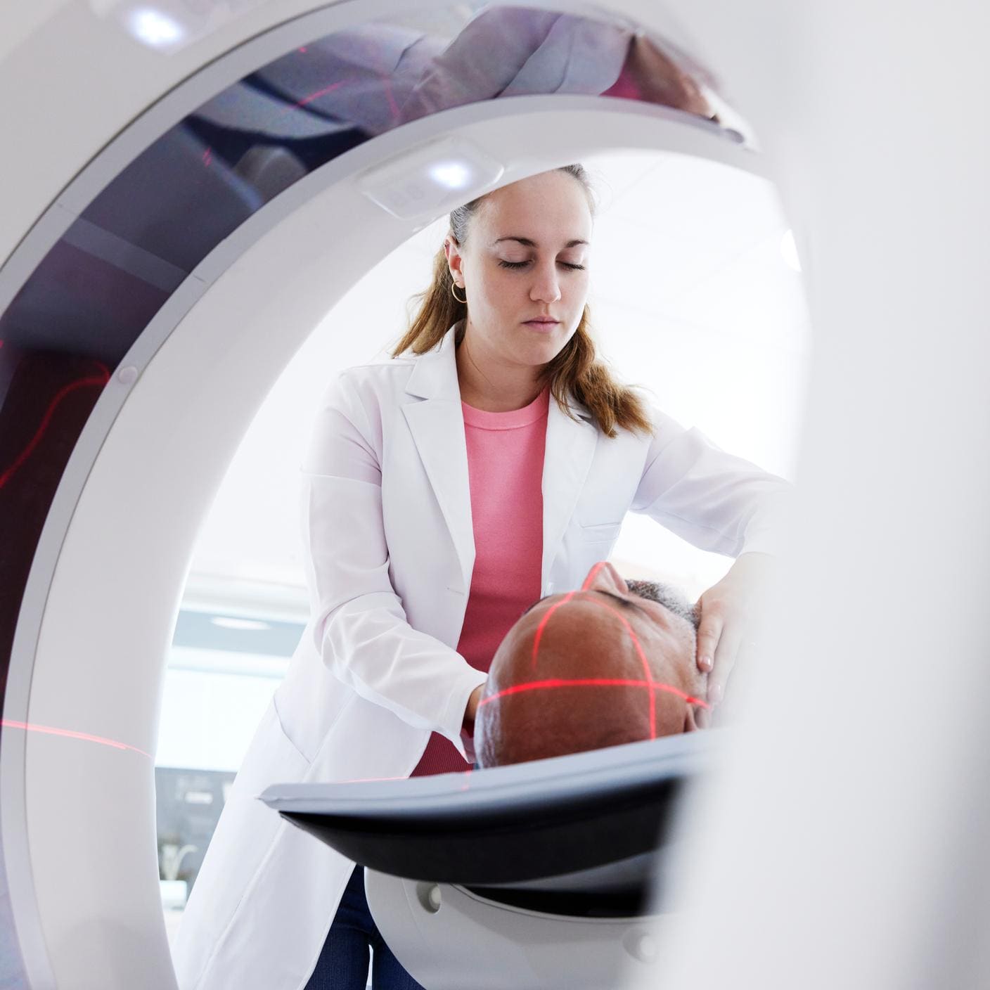 Female radiologist helping patient in medical x-ray scannertion for active medical devices