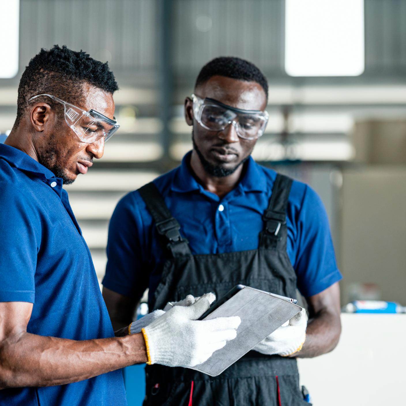 Men wearing eyewear protection in factory 