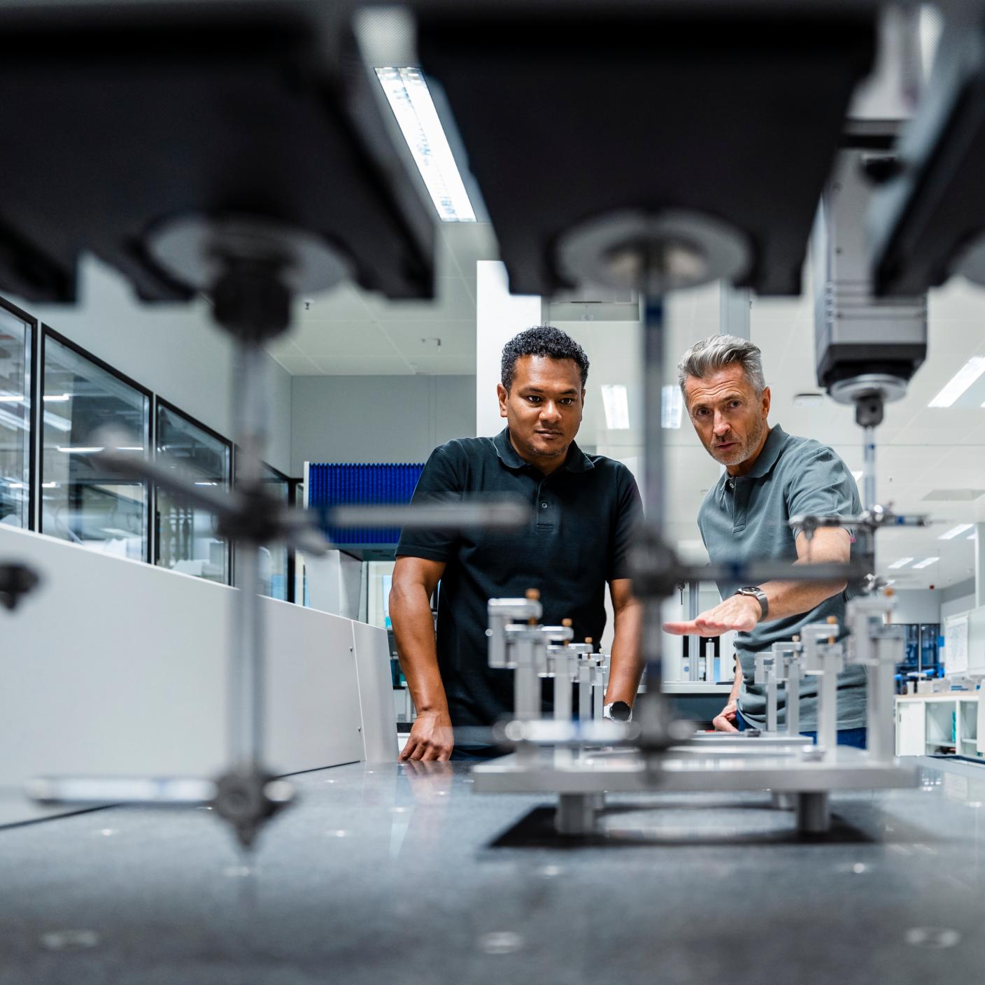 Engineers discussing over machinery at factory