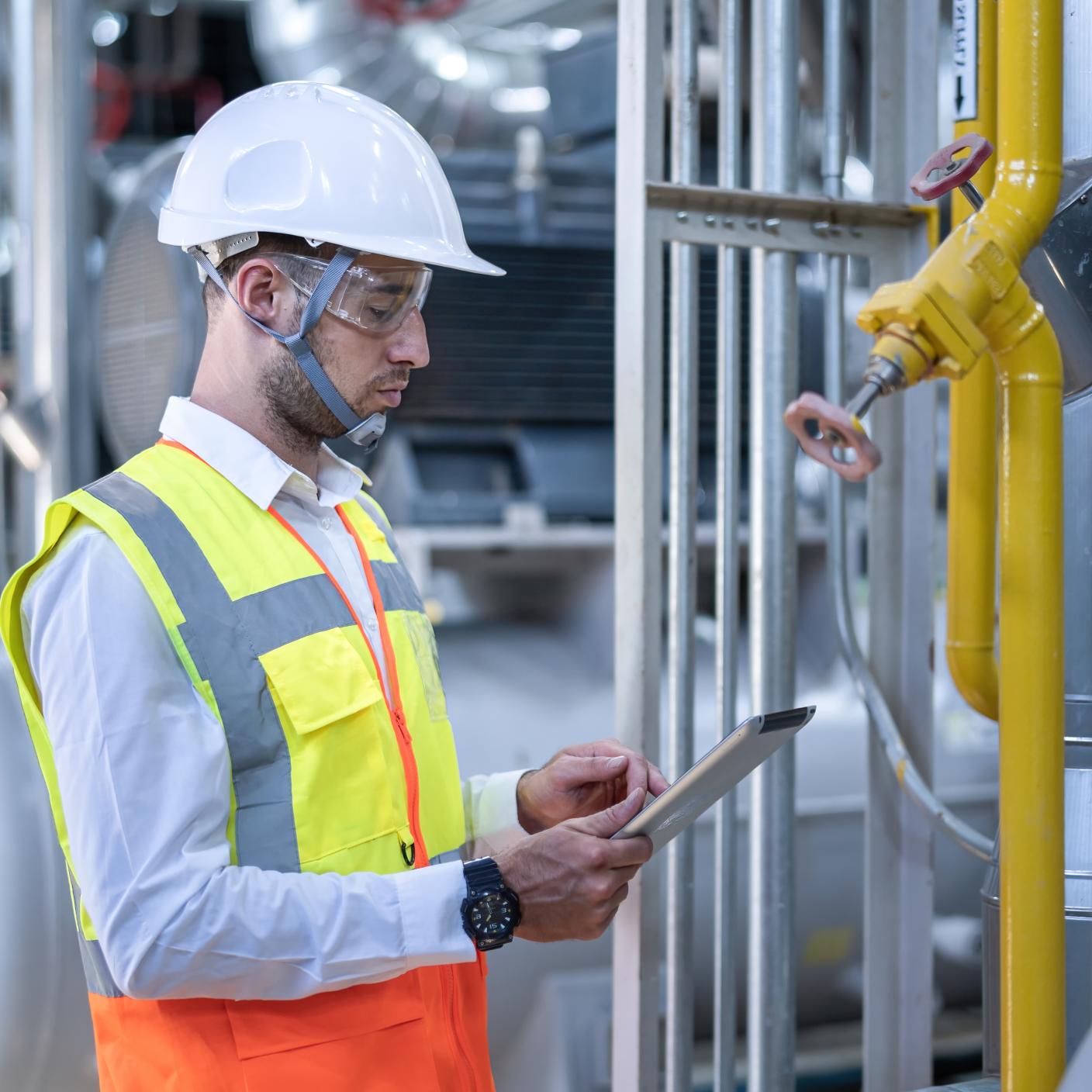 Man using iPad while wearing PPE 