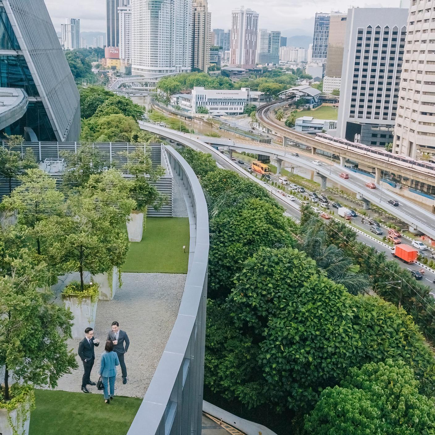 Above 3 business person talking on roof top garden outside office building