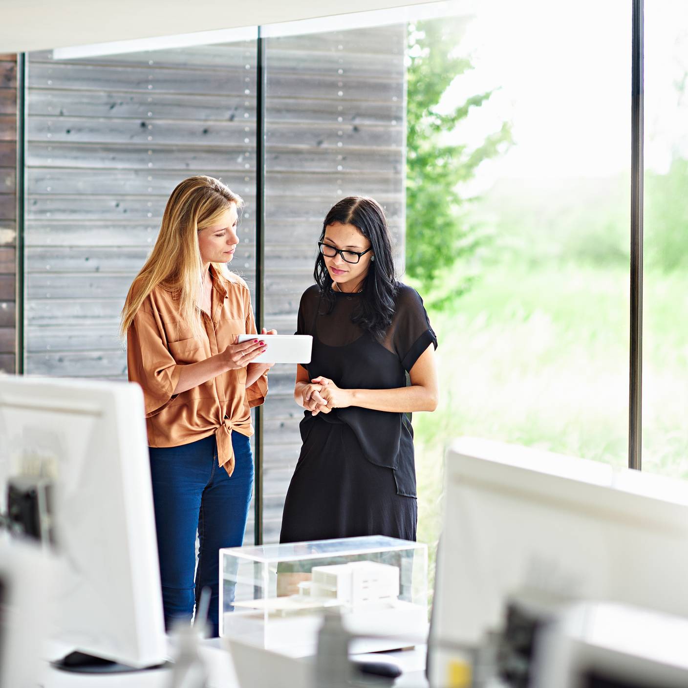 Accelerate innovation and achieve market access with expert building hardware testing and certification - Two women in a meeting