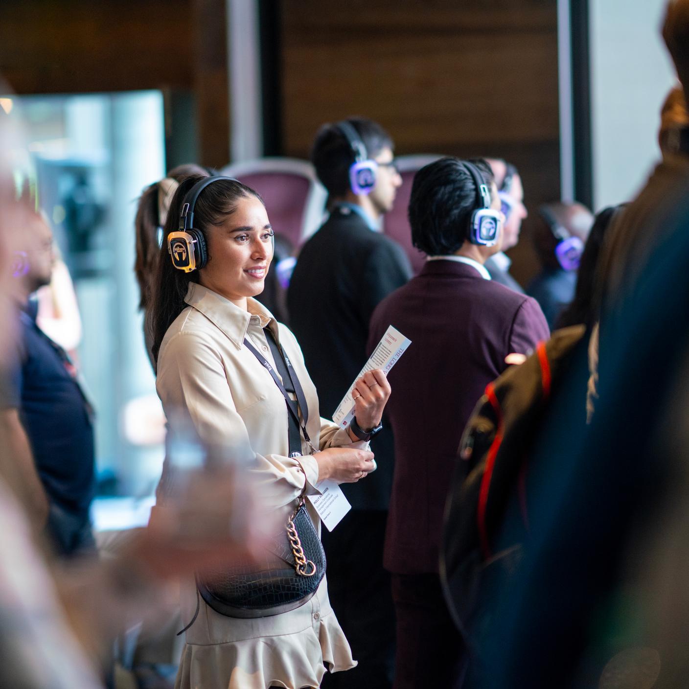 girl using headphones at conference