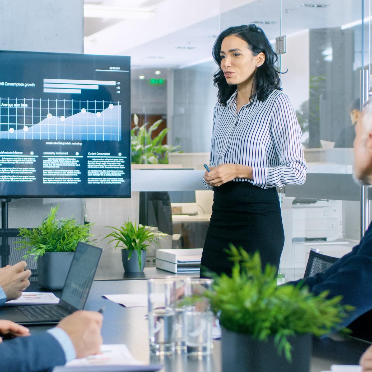 Businesswoman Gives Report/ Presentation to Her Business Colleagues in the Conference Room