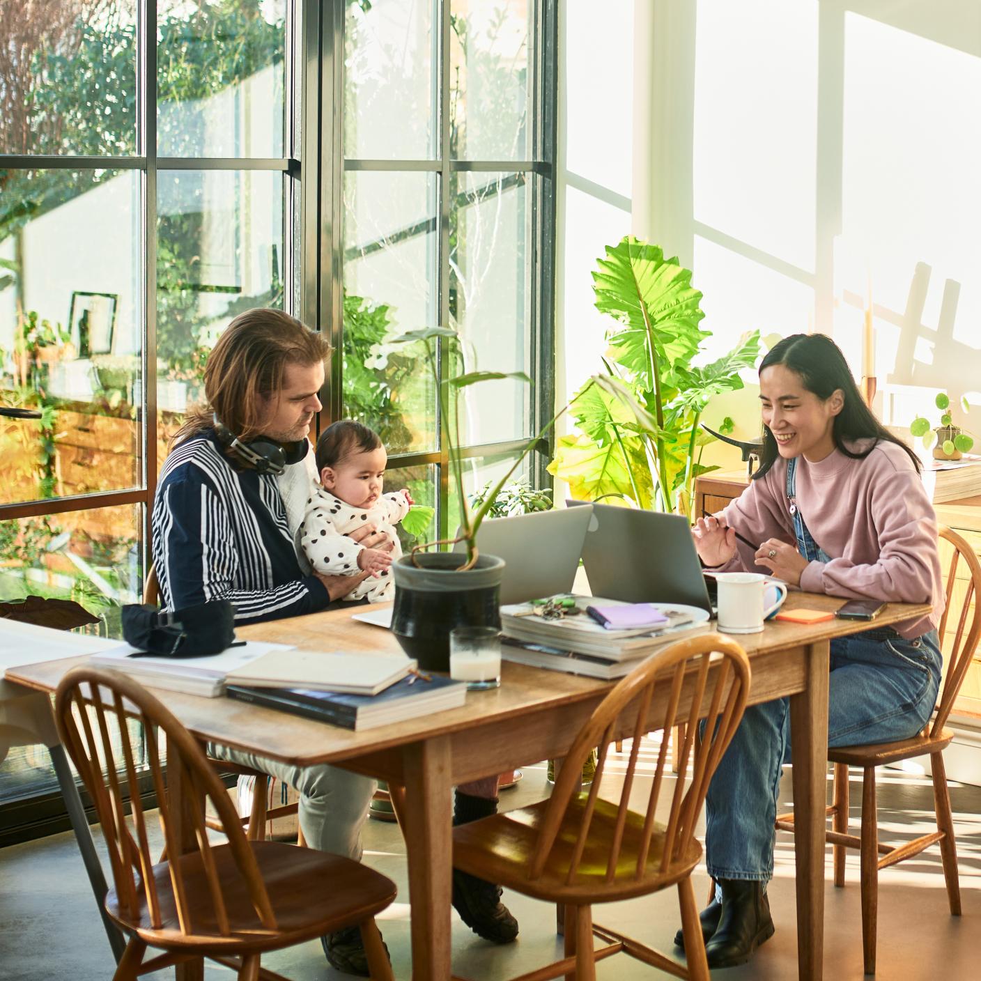 Women using laptop and speaking on video conference in home.