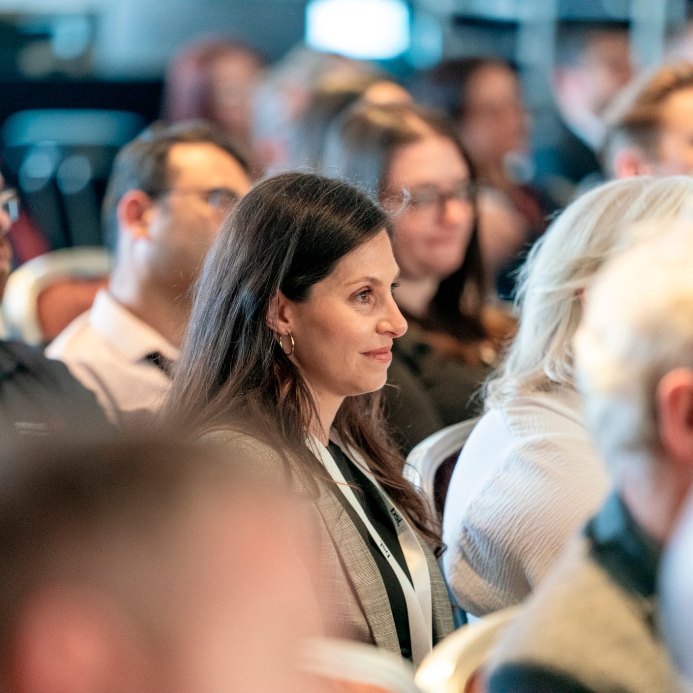 Woman at an event in the middle of the crowd