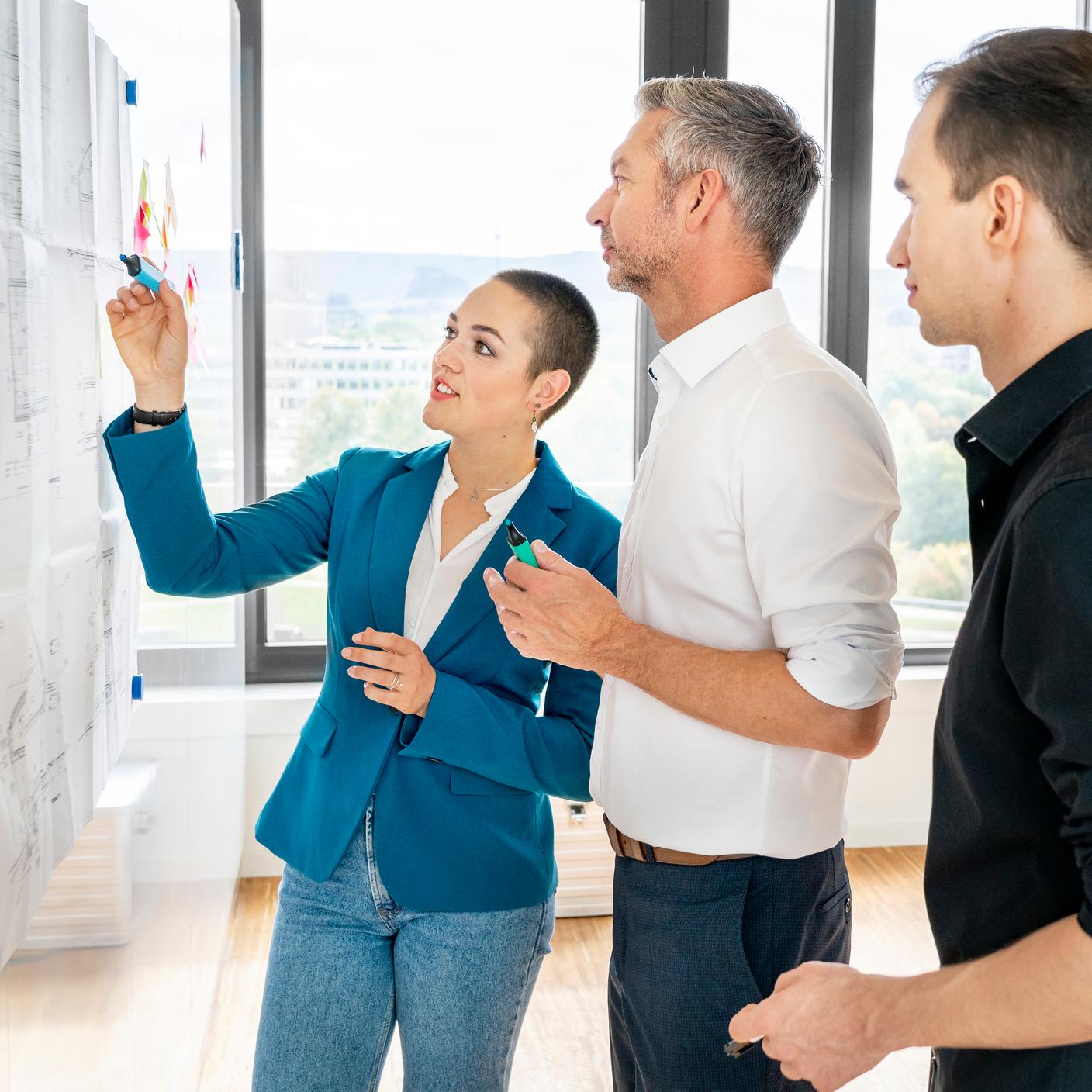 Team of business people at a whiteboard in office