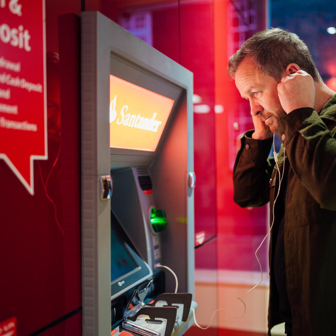 Consumer taking the money for shopping from the ATM