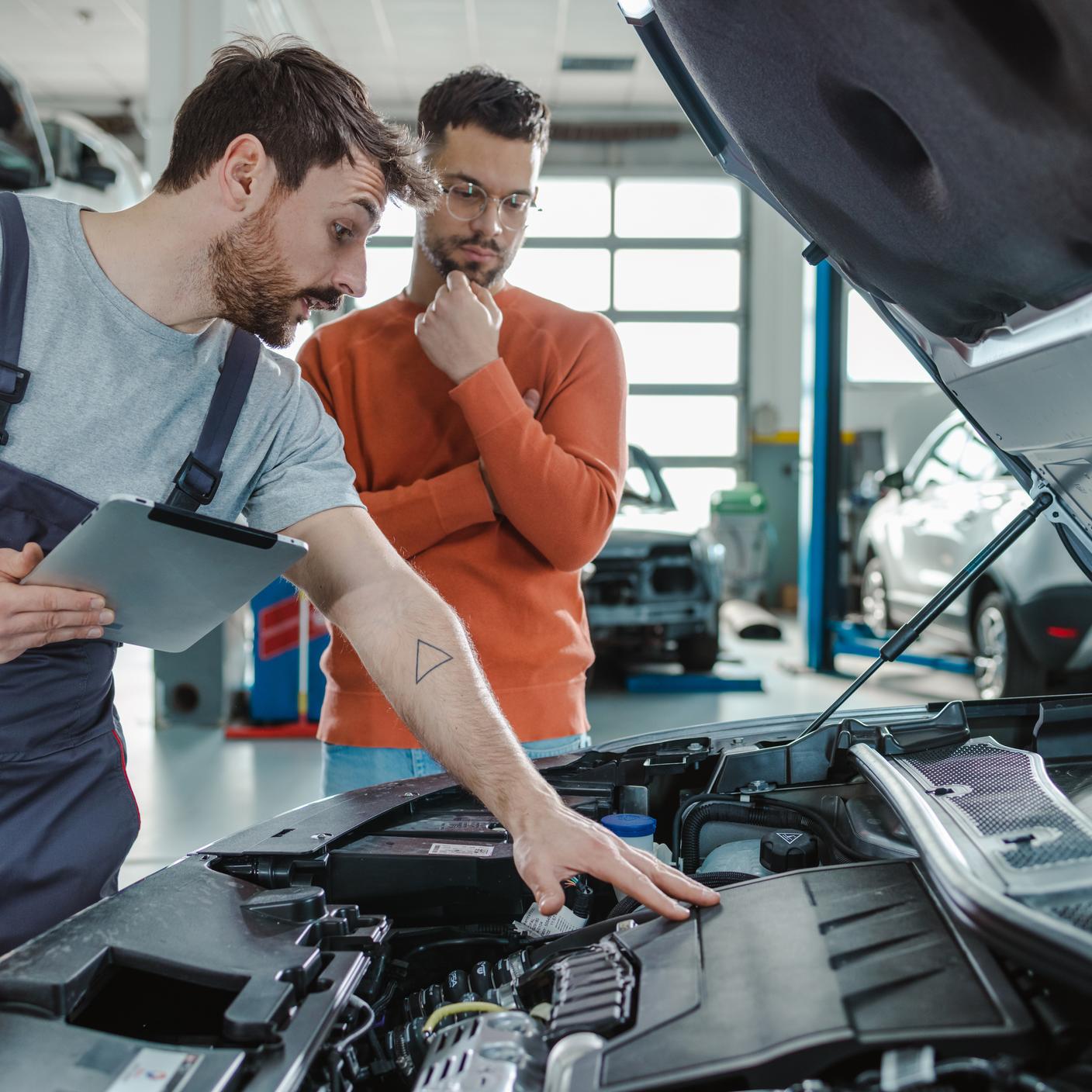 Two engineers looking at vehicle