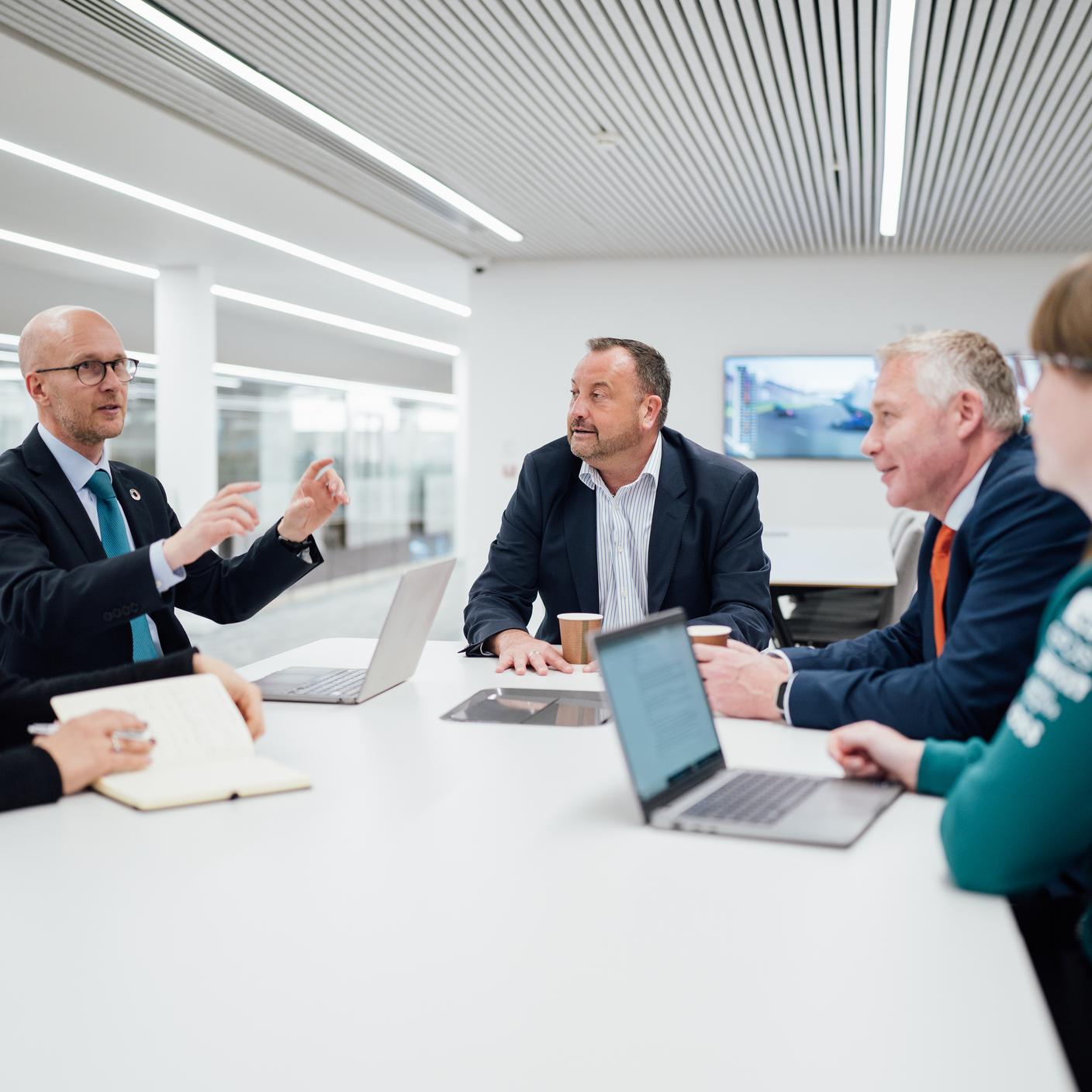 BSI and Aston Martin teams in meeting in smart office