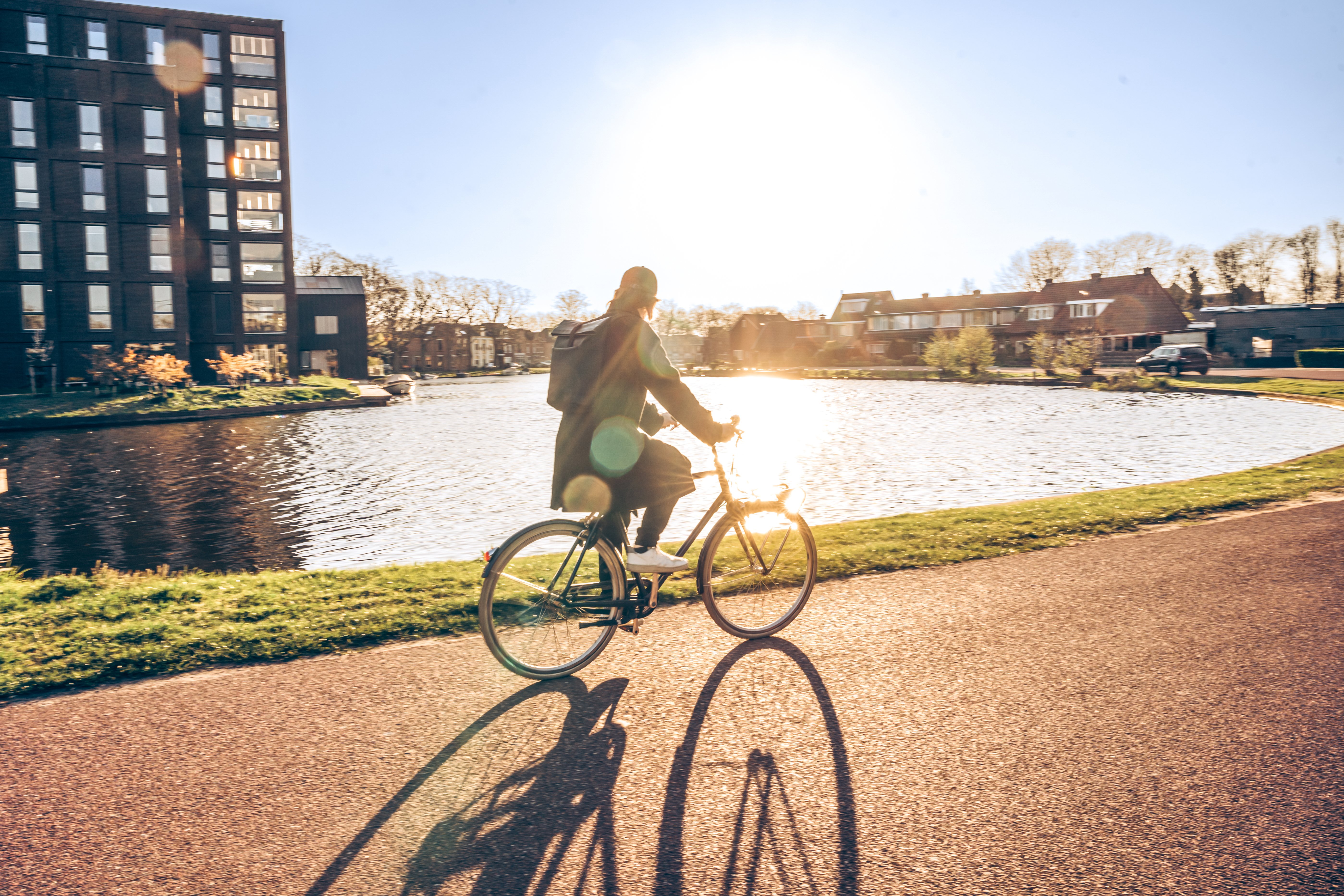 Quiet residential commute by bicycle along a scenic waterfront route. A modern answer to congestion and pollution