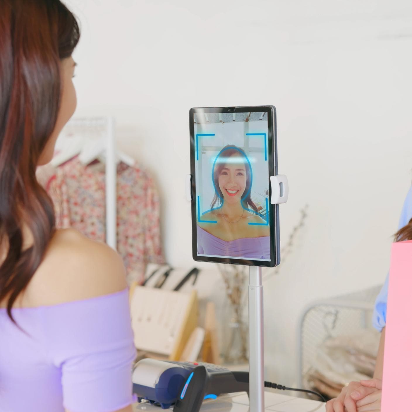 Girl use facial identification technology to make online credit card payment during shopping in store.