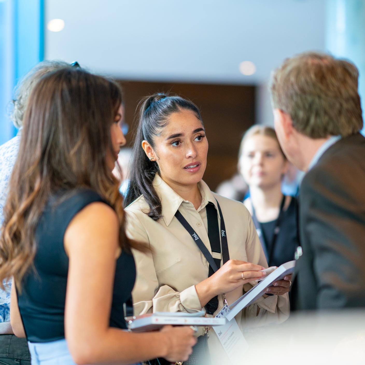 brochure - people discussing at conference