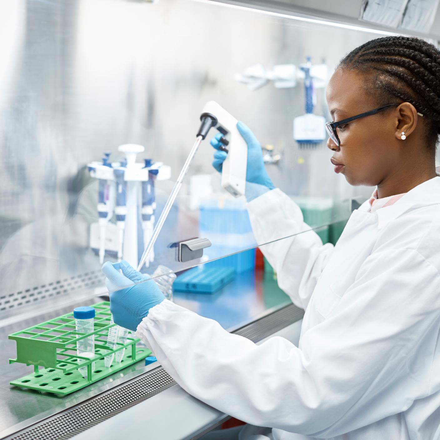 Female scientist analyzing medical sample in test tube.