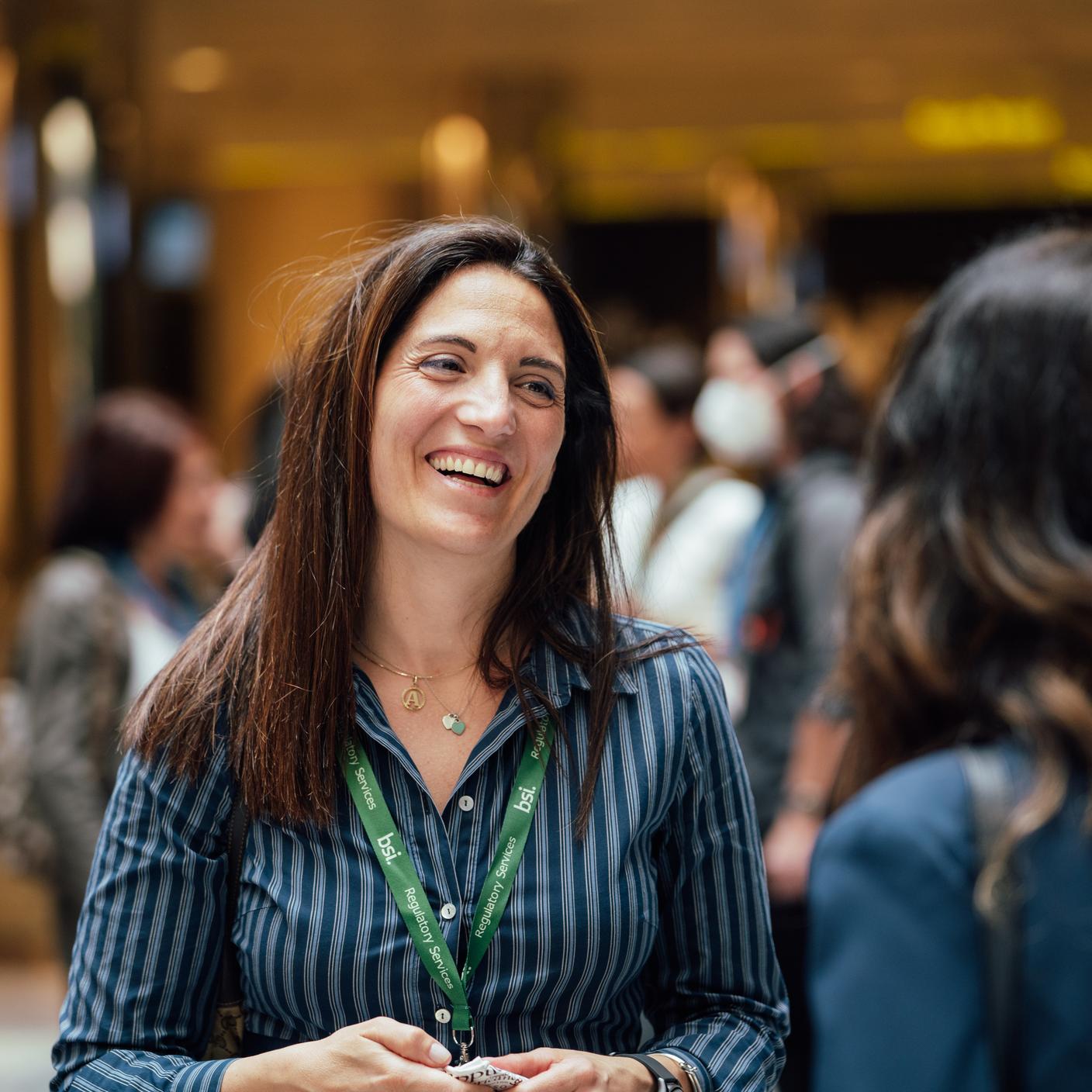 How we work with our clients - a group of people discussing at a conference