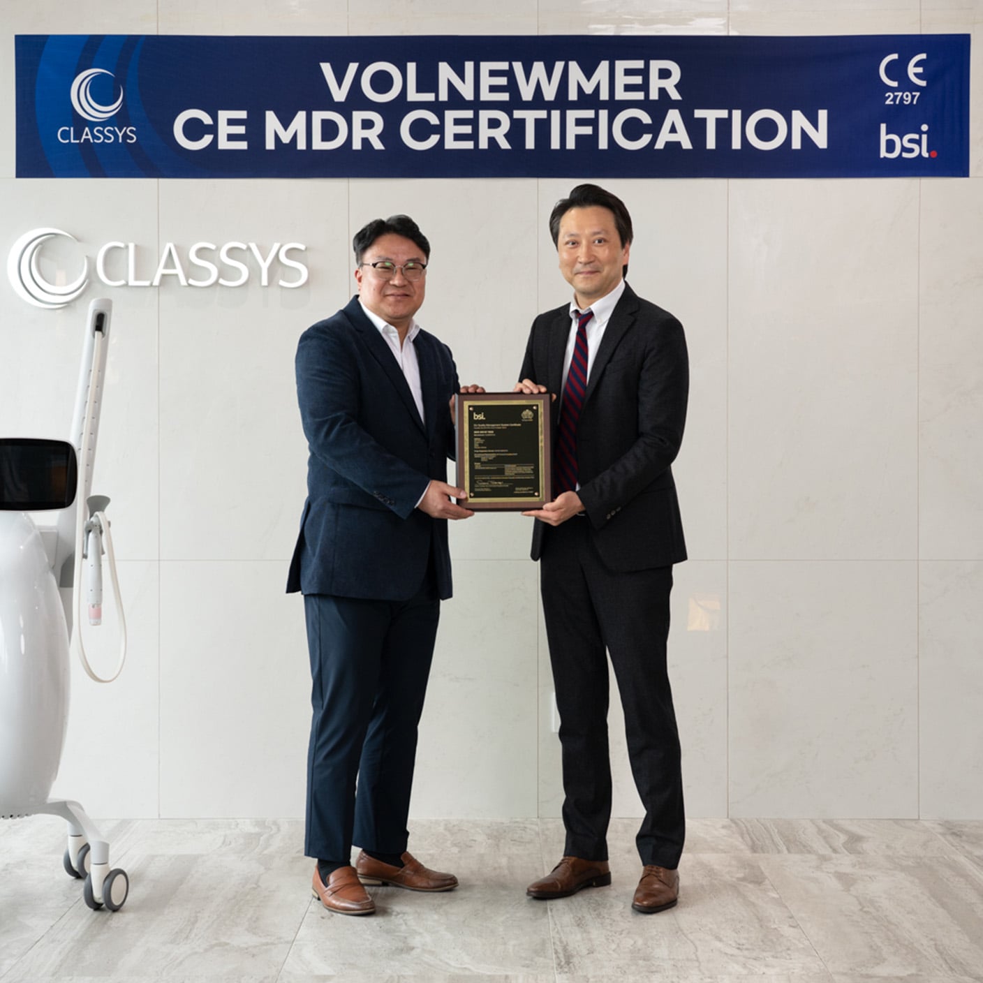 Two employees of CLASSYS holding certification.