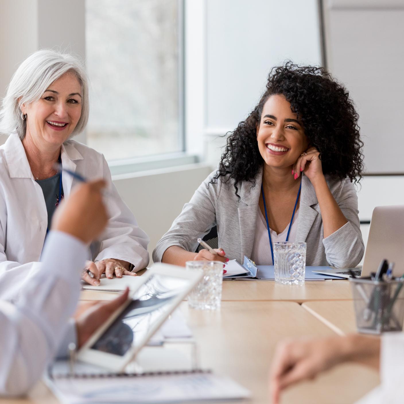Doctors collaborate in a meeting, discussing patient care and research with engagement and teamwork.