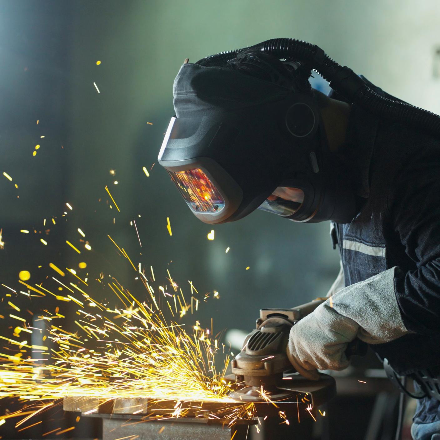 A grinder worker in a manufacturing plant