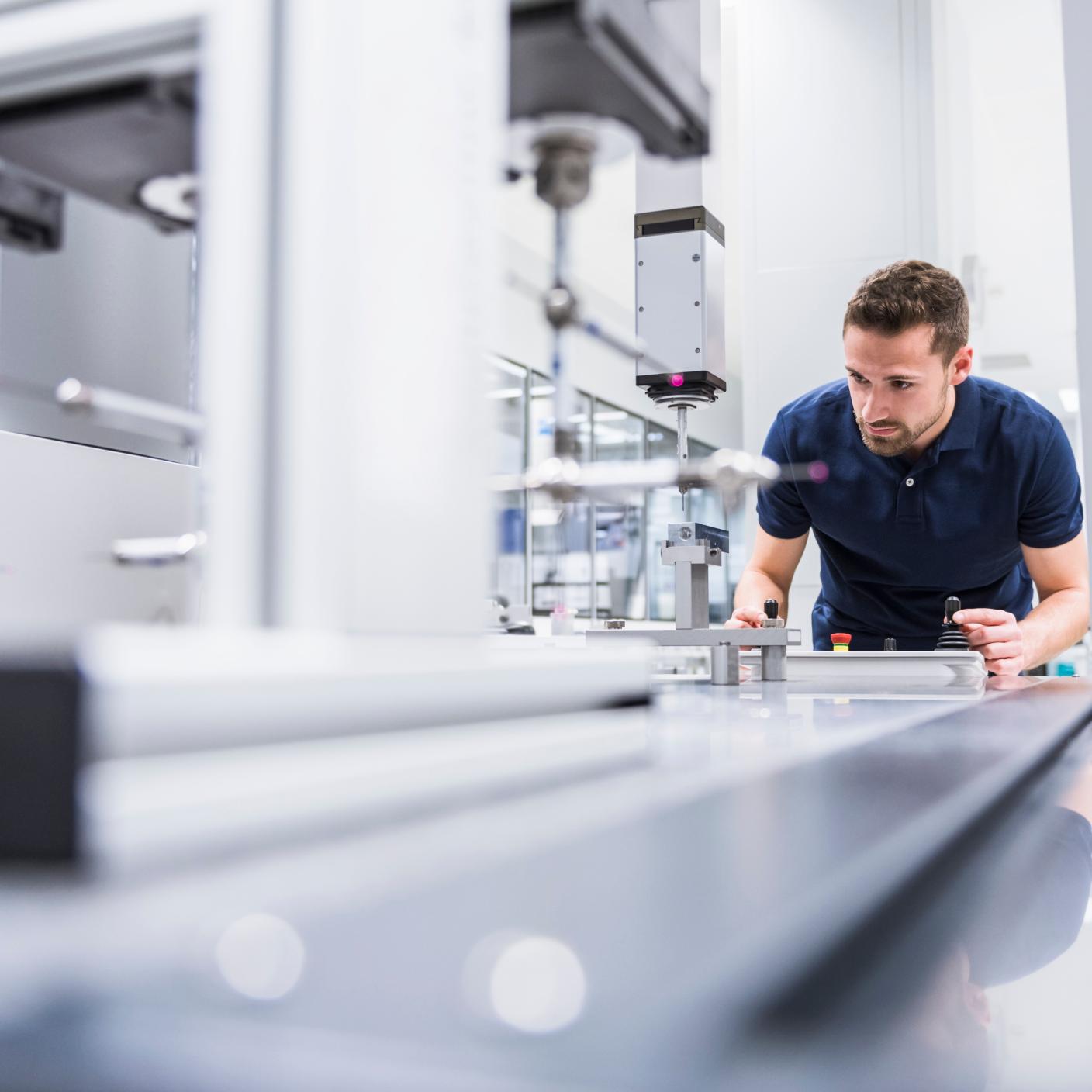Man operating machinery in factory 