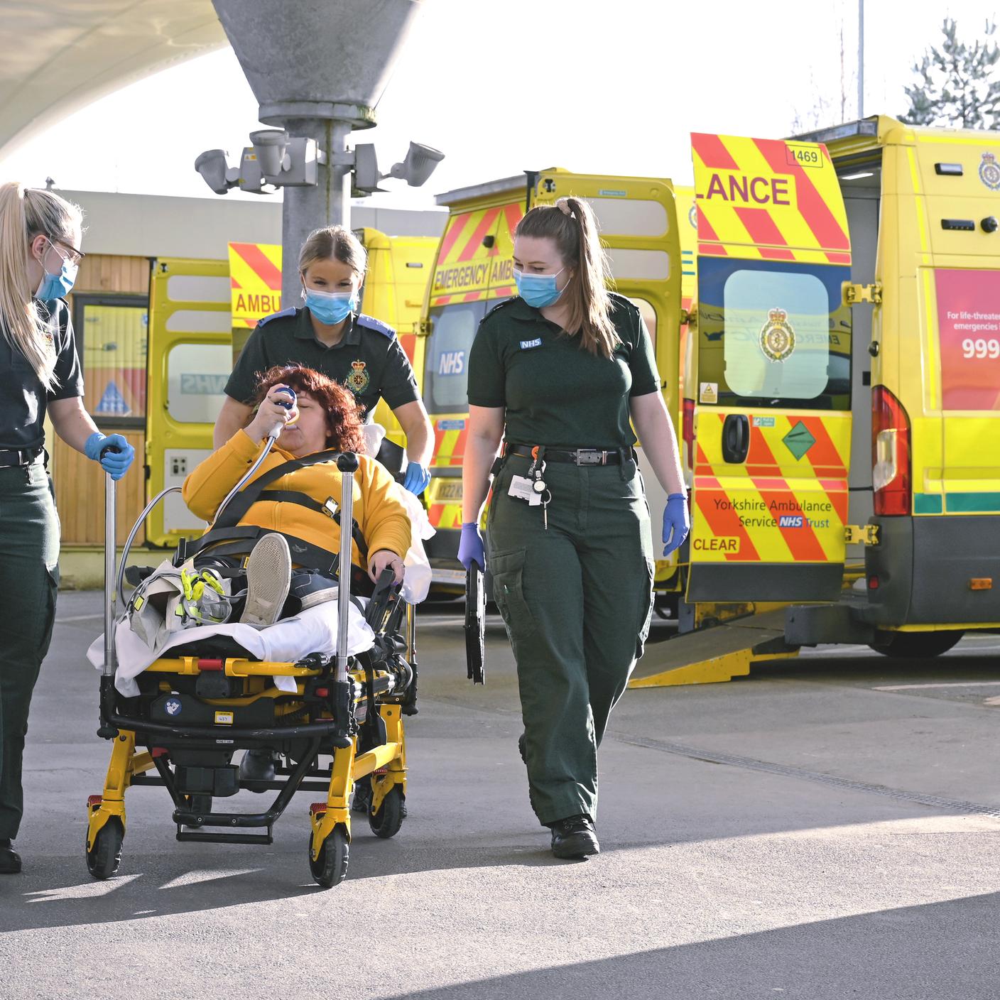 Paramedic women taking care of another woman in a wheelchair