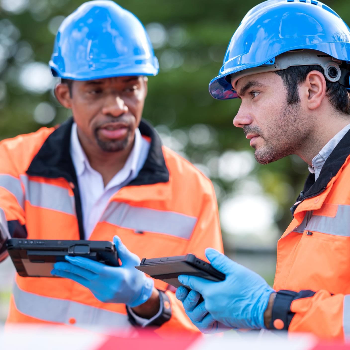 Air Pollution Monitoring and Environmental Sustainability. Diversity of Team engineers in field operation of air quality monitoring having a discussion and collecting data of monitoring device at an air monitoring station outdoors.