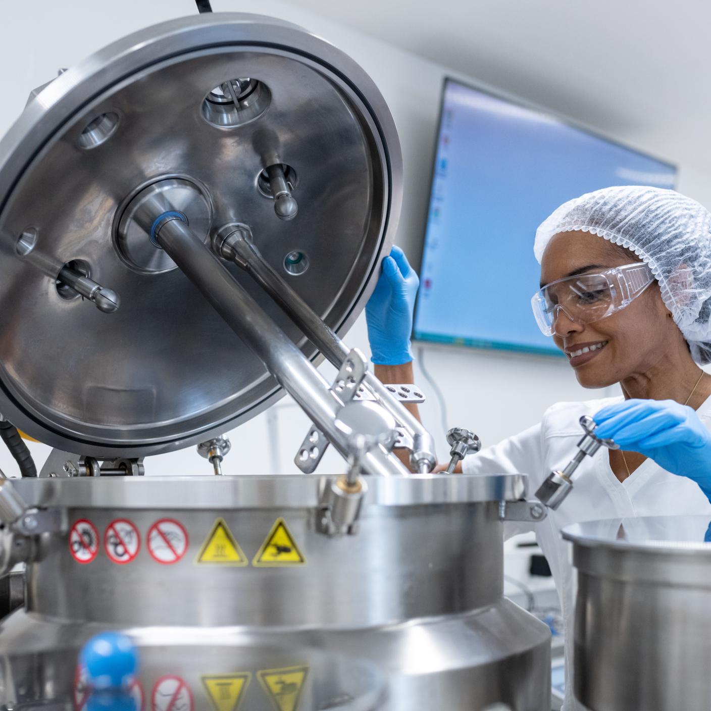 Multiracial group of female workers, pharmacists and researchers in biochemical pharmaceutical production during pharmaceutical manufacturing.