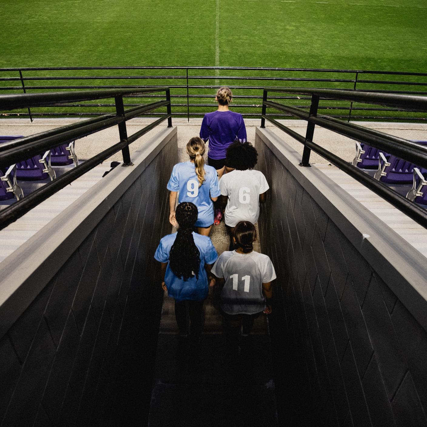 Girls soccer team players entering field from under stadium. Superfeet client provided image for use on their Case Study design and web page only.