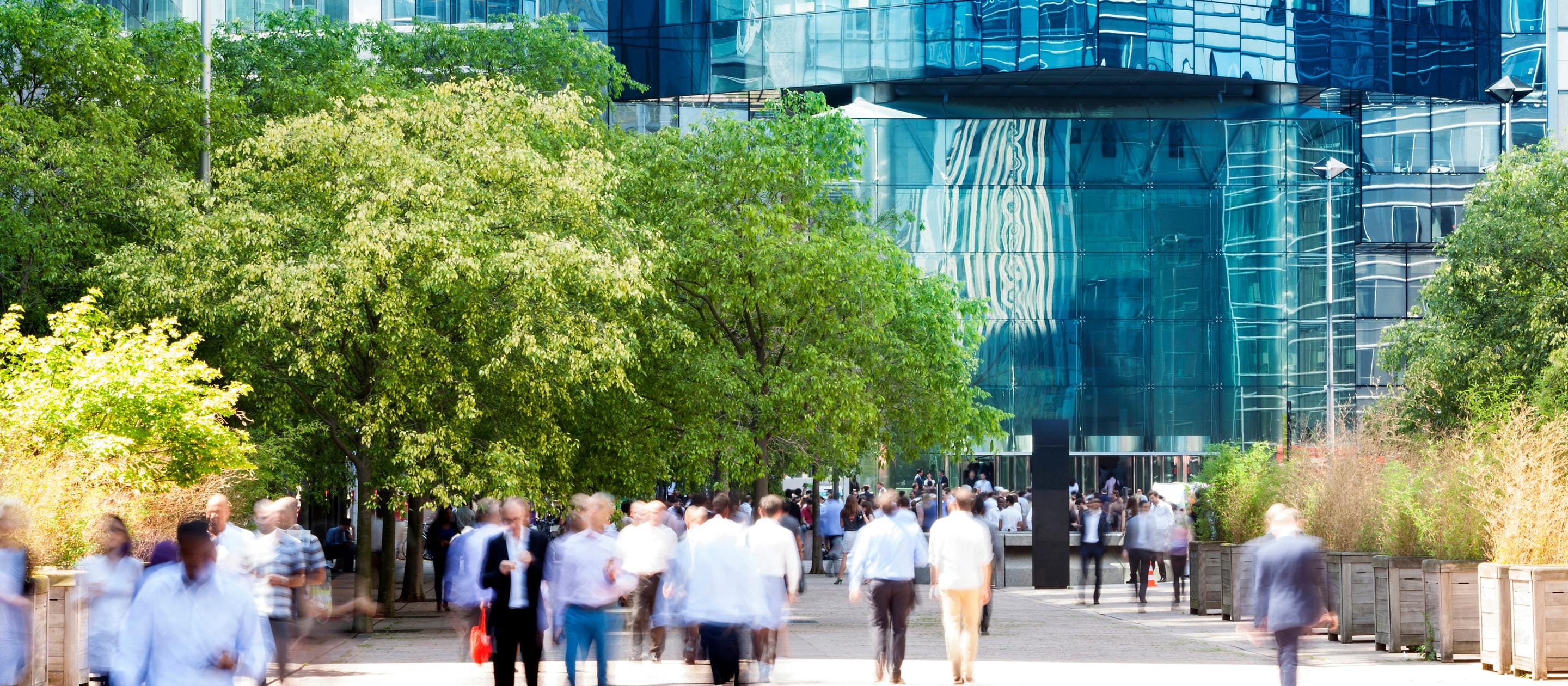 city scape shot of garden office roof top with people outside meeting