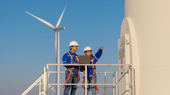 Quality - Maintenance engineers are checking wind turbines at wind power plant electric energy station
