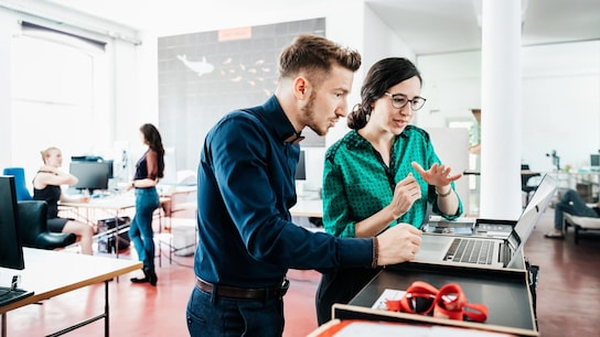 man and woman discussing in office