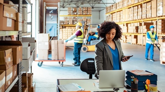 Close up of a warehouse manager using a laptop