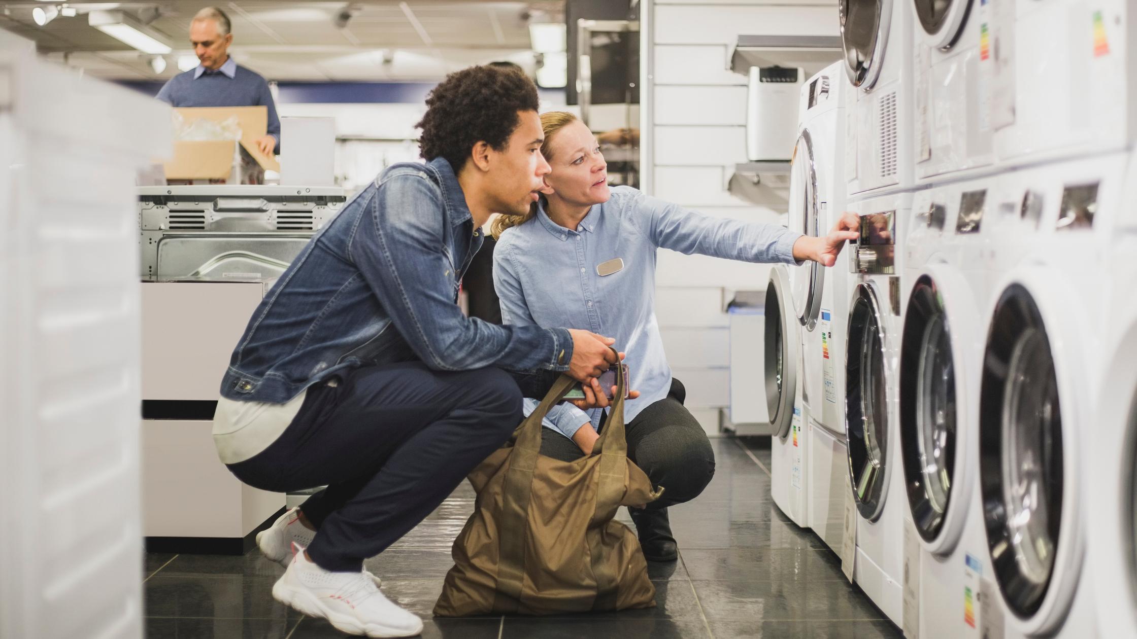 Sustainability in manufacturing - man shopping for washing machine