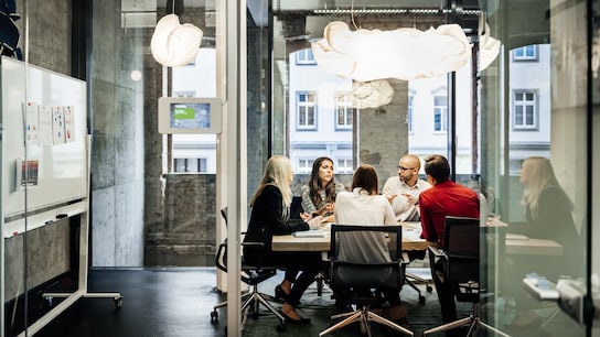 A group of people is sitting at a table during a business meeting