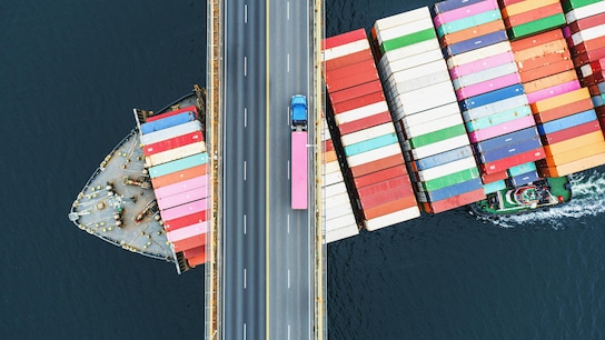 A clear view of your supply chain - cargo ship under bridge