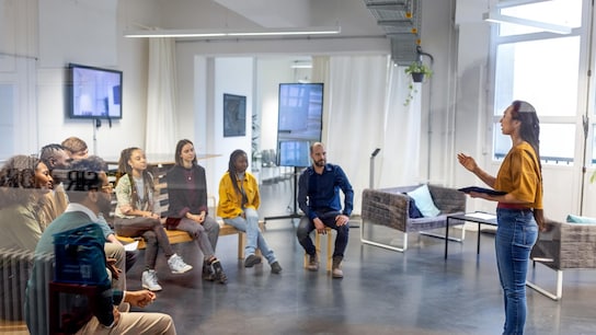 Young asian businesswoman speaking to her coworkers in meeting