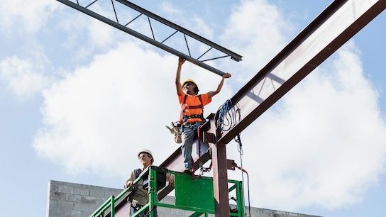 Multiple construction workers with structures.