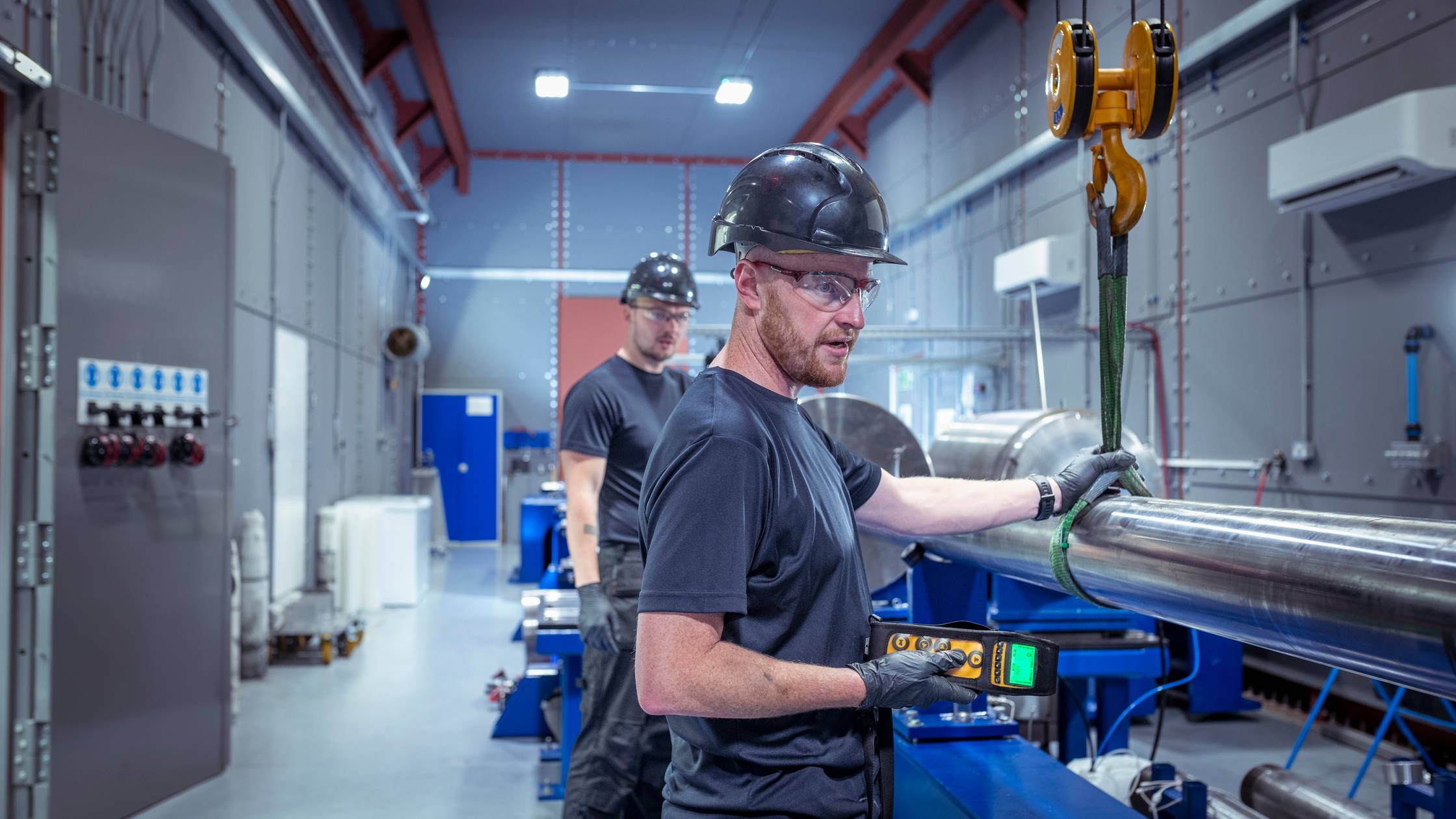 Engineers fitting new barrel to a two stage gas gun which creates nuclear fusion in a nuclear fusion research facility.