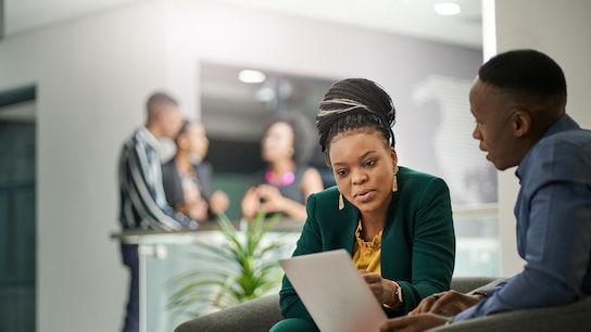 Business people brainstorming in office lobby