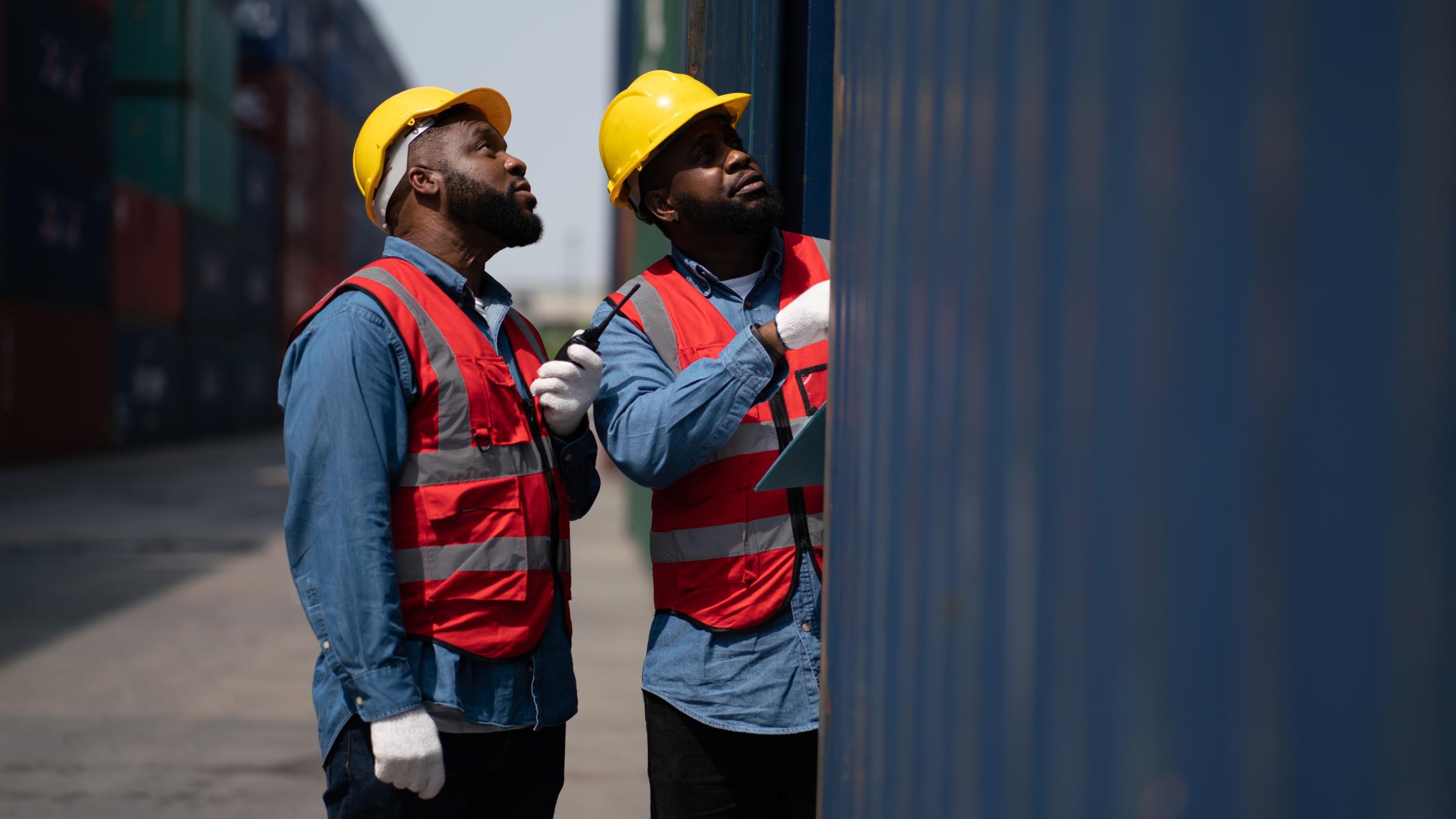 Adults work professionally transporting goods.man business engineer in container transportation industry.Shipping Container Distribution Warehouse Technology