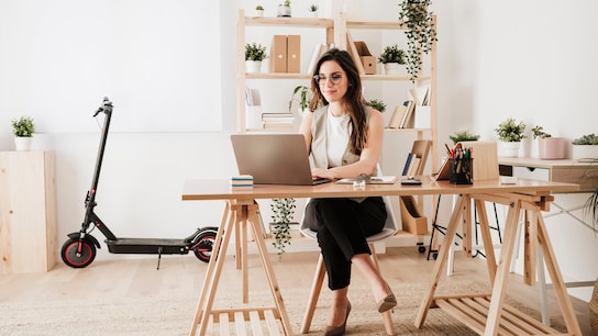 Businesswoman using laptop at desk in office
