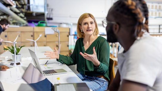 Woman giving suggestions to her team during meeting at startup office