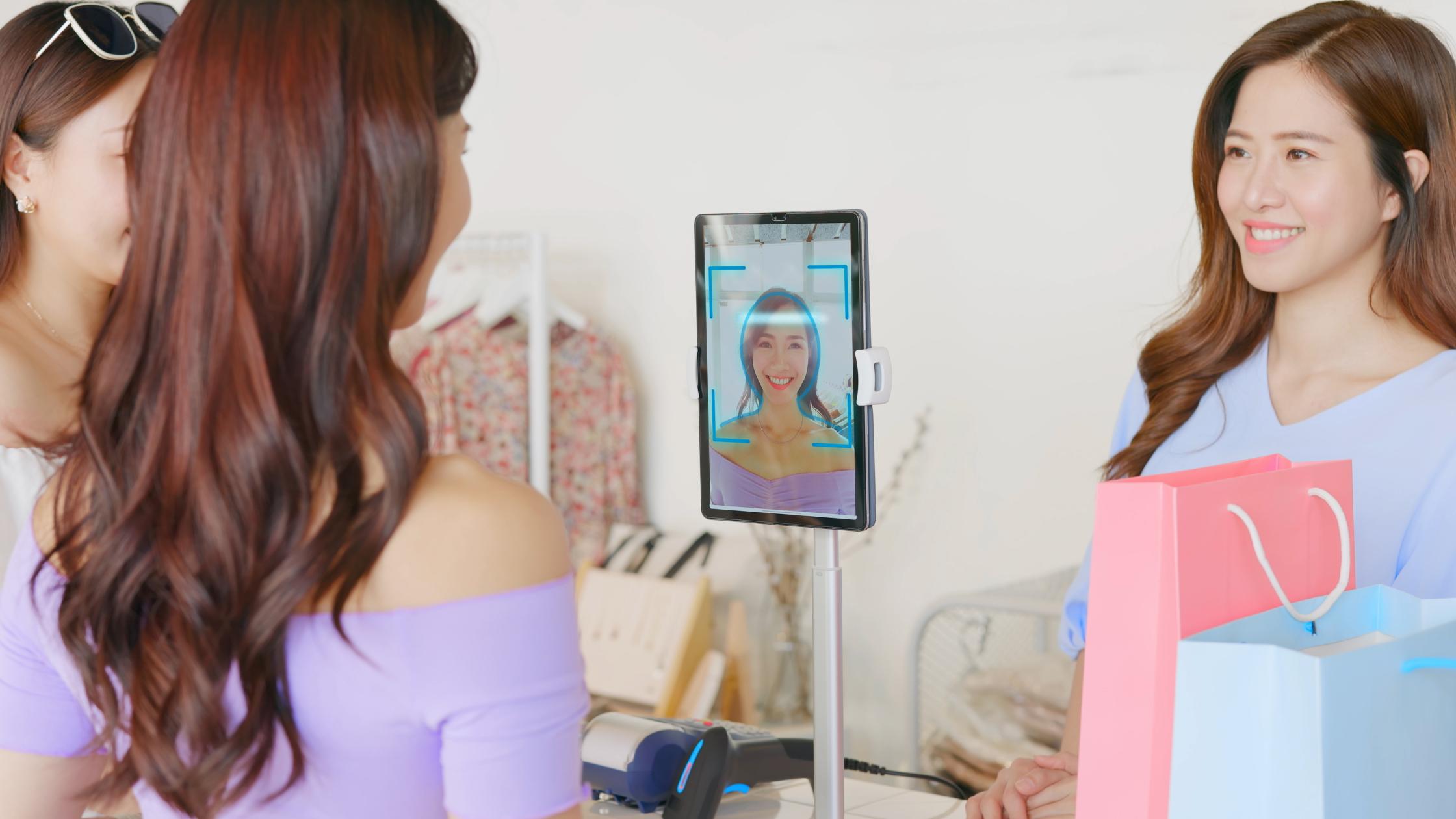 Person use facial identification technology to make online credit card payment during shopping in store.