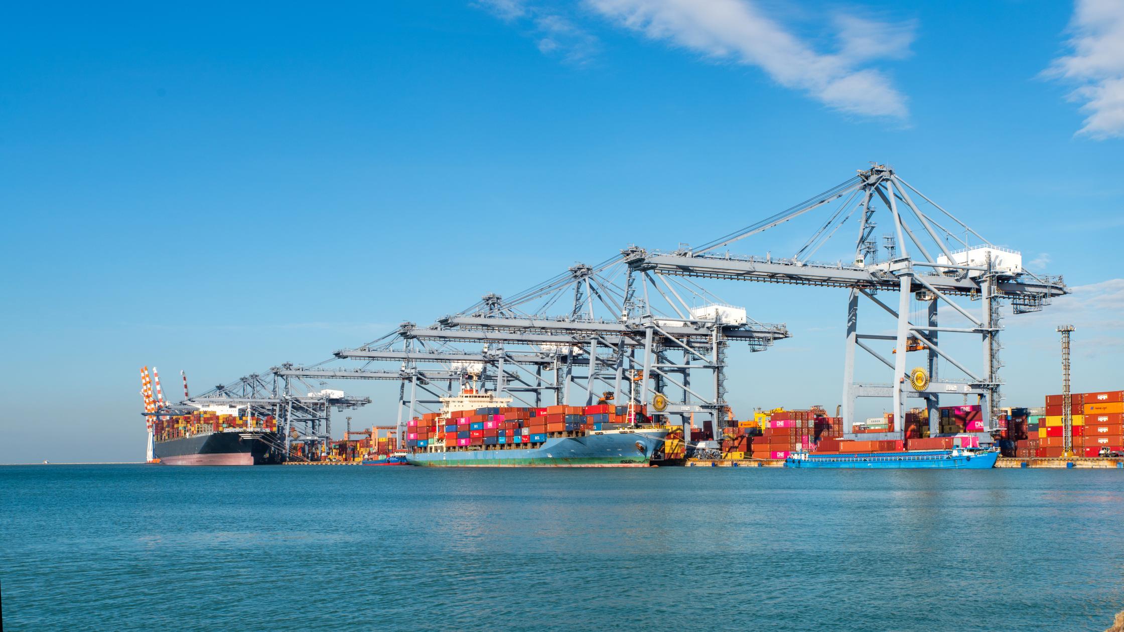 Image for Standards Partnership programme, to be used across marketing communications including event materials, social media, website etc. Container ship loading and unloading in sea port, aerial view of business logistic import and export freight transportation by container ship in harbor, container loading Cargo freight ship.
