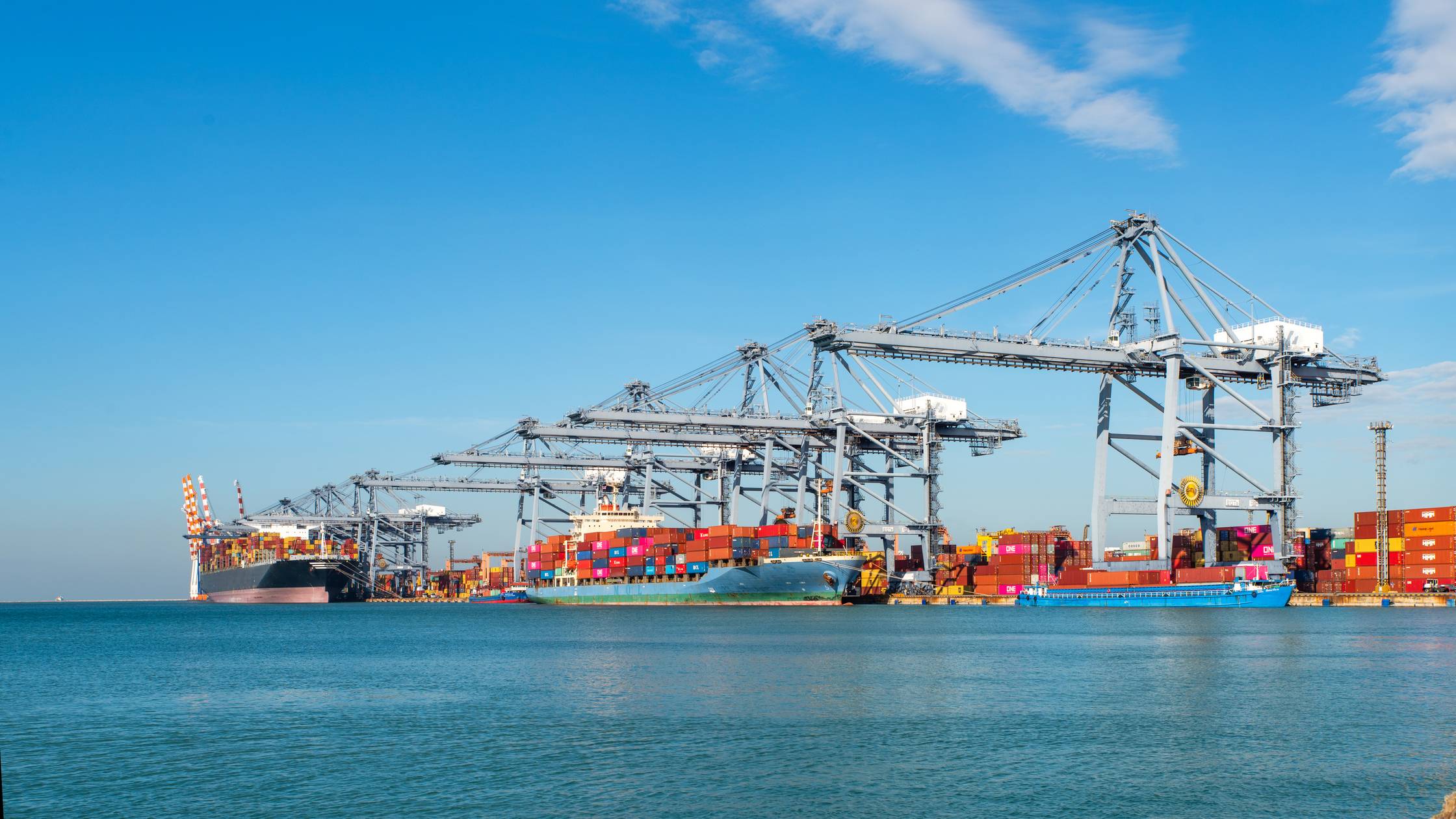 Image for Standards Partnership programme, to be used across marketing communications including event materials, social media, website etc. Container ship loading and unloading in sea port, aerial view of business logistic import and export freight transportation by container ship in harbor, container loading Cargo freight ship.